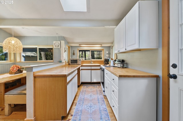 625 Wilson Rd, Mosier, OR 97040 - kitchen featuring stainless steel microwave, butcher block counters, electric stove, and light wood-style flooring