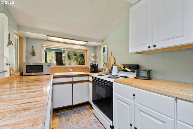 625 Wilson Rd, Mosier, OR 97040 - kitchen with range with electric stovetop, stainless steel microwave, a sink, white cabinetry, and wood finished floors