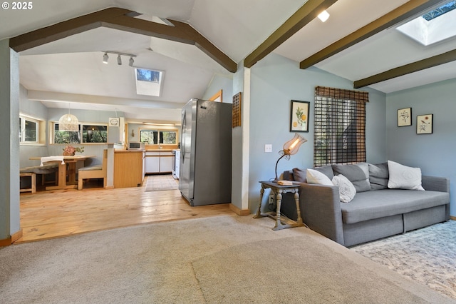 625 Wilson Rd, Mosier, OR 97040 - living room featuring a skylight, light colored carpet, light wood-style floors, and baseboards