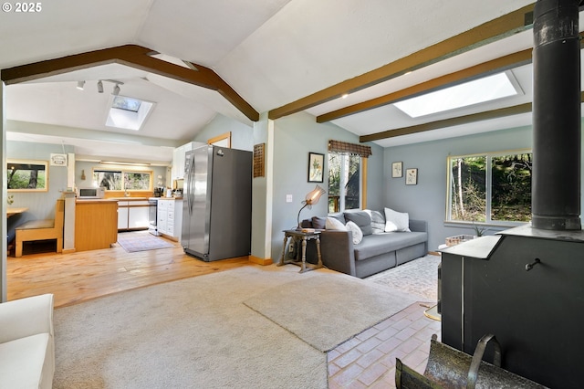 625 Wilson Rd, Mosier, OR 97040 - living area with a skylight, lofted ceiling, plenty of natural light, light colored carpet, and light wood-style floors