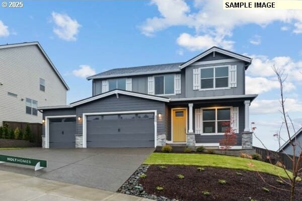 16513 SE Smith Rock St Unit 732, Happy Valley, OR 97086 - craftsman inspired home featuring stone siding, covered porch, an attached garage, driveway, and a front yard