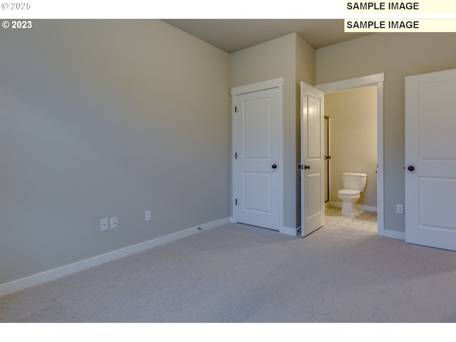 16513 SE Smith Rock St Unit 732, Happy Valley, OR 97086 - unfurnished bedroom with light carpet, baseboards, and ensuite bathroom