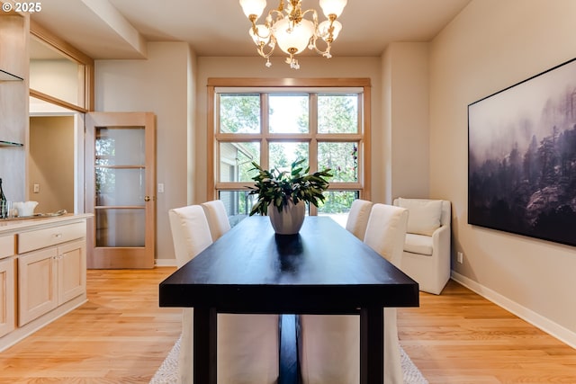 2405 Blacktail Dr, Eugene, OR 97405 - dining room with a chandelier, light wood finished floors, and baseboards
