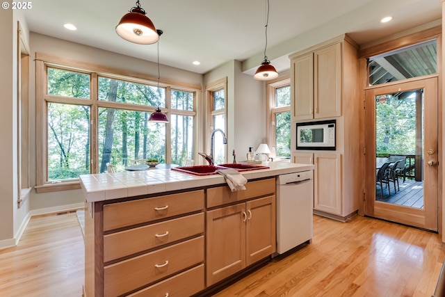 2405 Blacktail Dr, Eugene, OR 97405 - kitchen with white appliances, a sink, light wood-style floors, hanging light fixtures, and an island with sink