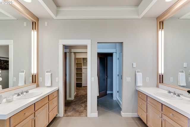 2405 Blacktail Dr, Eugene, OR 97405 - bathroom with two vanities, tile patterned floors, baseboards, and a spacious closet