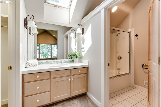 2405 Blacktail Dr, Eugene, OR 97405 - bathroom featuring vanity, combined bath / shower with glass door, a skylight, baseboards, and tile patterned flooring