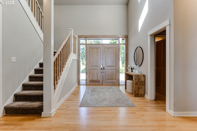 2405 Blacktail Dr, Eugene, OR 97405 - entryway with stairs, light wood finished floors, baseboards, and a high ceiling