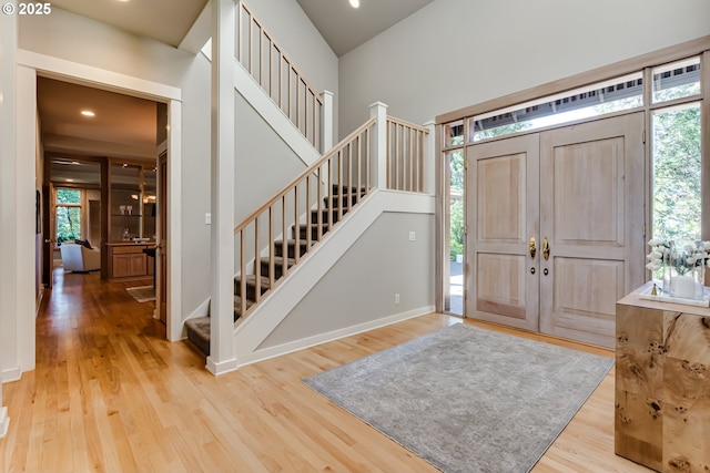 2405 Blacktail Dr, Eugene, OR 97405 - entrance foyer with stairs, healthy amount of natural light, wood finished floors, recessed lighting, and baseboards
