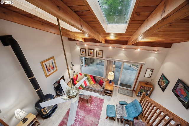231 E Dunoon Pl, Shelton, WA 98584 - living area featuring a skylight, a wood stove, beam ceiling, and wooden ceiling