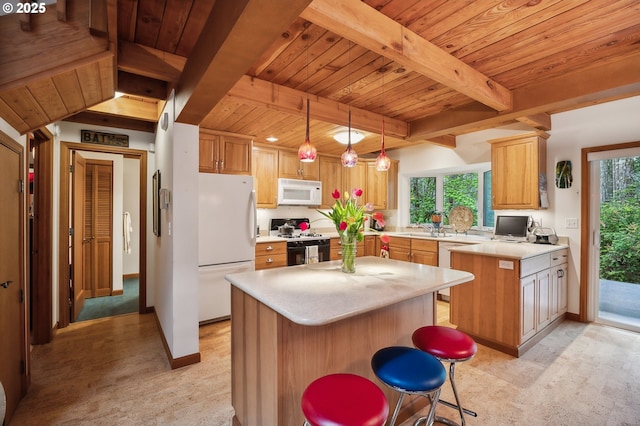 231 E Dunoon Pl, Shelton, WA 98584 - kitchen featuring white appliances, wood ceiling, light countertops, beamed ceiling, and a center island