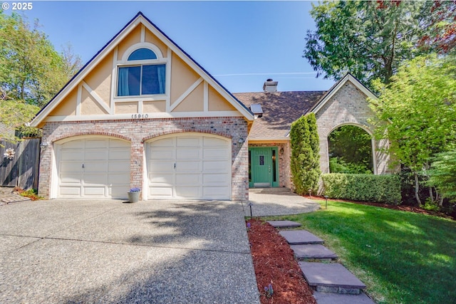 view of front facade featuring stucco siding, brick siding, and driveway