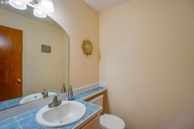 half bathroom featuring toilet and vanity