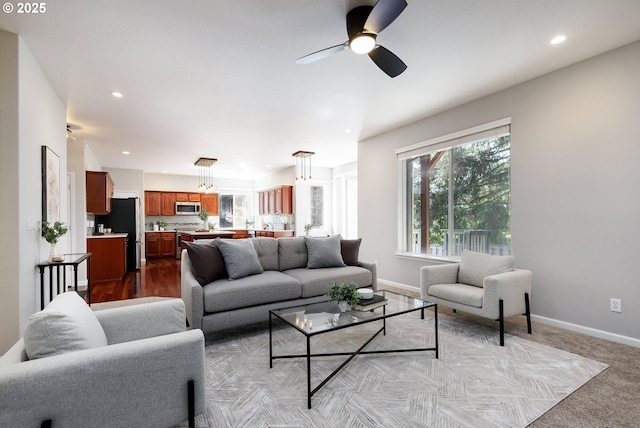 living area featuring a ceiling fan, baseboards, and recessed lighting