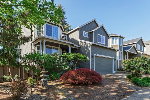 craftsman house featuring fence, an attached garage, and driveway