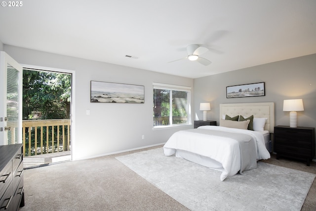 carpeted bedroom featuring visible vents, a ceiling fan, multiple windows, and access to exterior