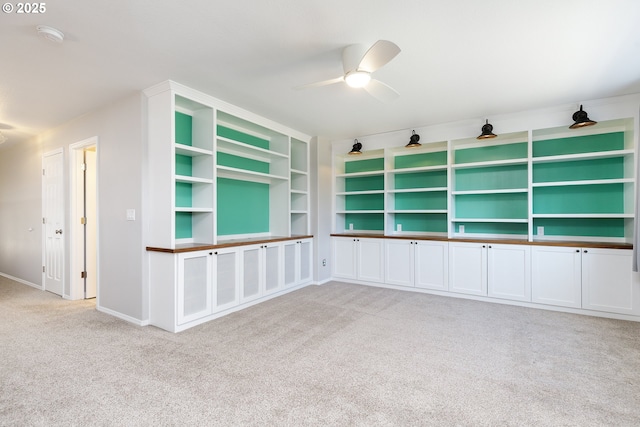 unfurnished room featuring carpet floors, ceiling fan, and baseboards