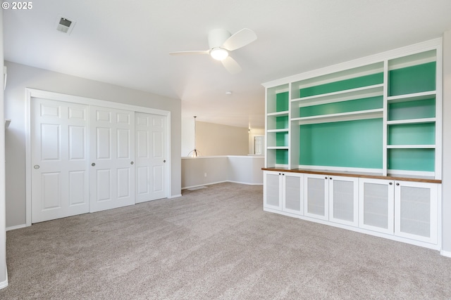 unfurnished living room featuring ceiling fan, visible vents, baseboards, and carpet