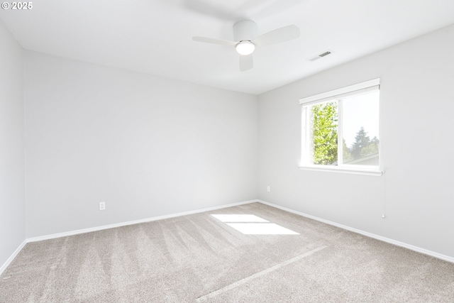 unfurnished room featuring carpet floors, baseboards, and visible vents