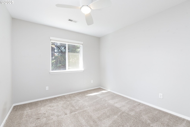 unfurnished room with visible vents, a ceiling fan, baseboards, and carpet floors