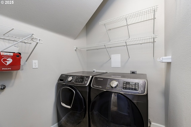 laundry room with baseboards, laundry area, and washing machine and dryer