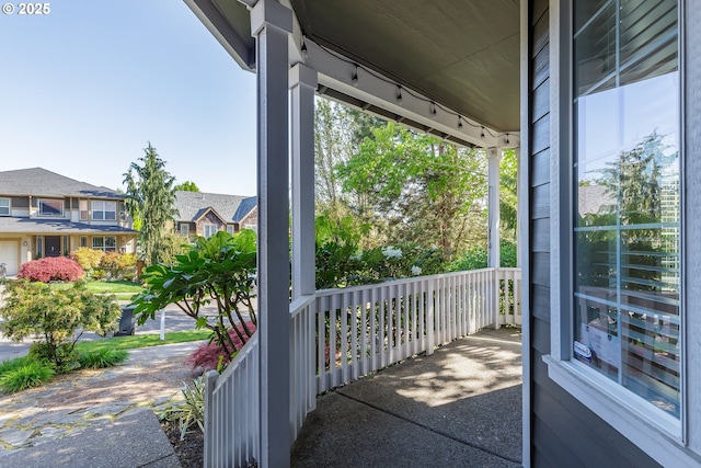 exterior space with covered porch and a residential view