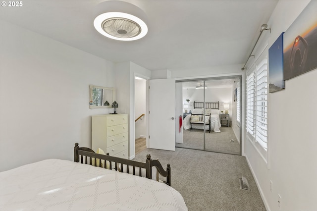 bedroom featuring carpet flooring, a closet, and multiple windows