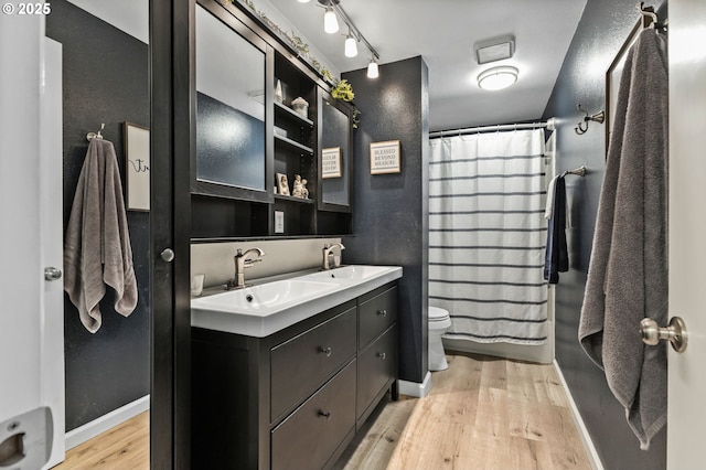 full bathroom featuring shower / tub combo with curtain, toilet, vanity, and wood-type flooring