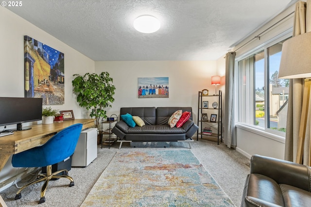 carpeted office space featuring a textured ceiling