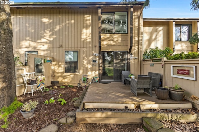 rear view of property featuring a deck