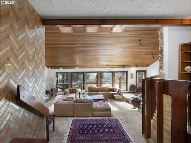 carpeted living room featuring beam ceiling, wood ceiling, and a wealth of natural light