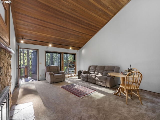 carpeted living room with high vaulted ceiling, a fireplace, and wooden ceiling