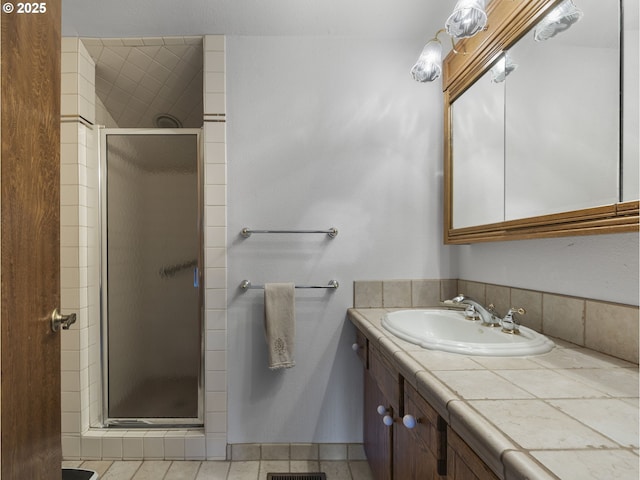 bathroom with vanity, tile patterned floors, and walk in shower