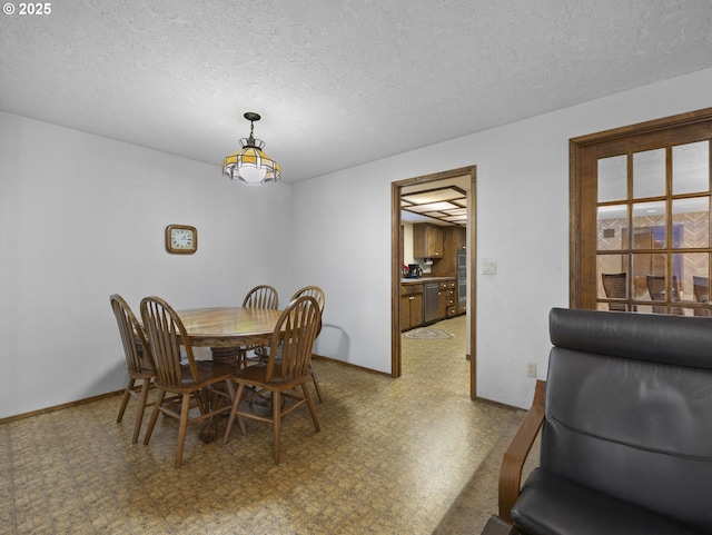 dining space featuring a textured ceiling