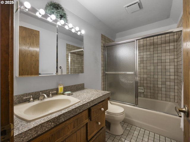 full bathroom with tile patterned flooring, vanity, toilet, and combined bath / shower with glass door