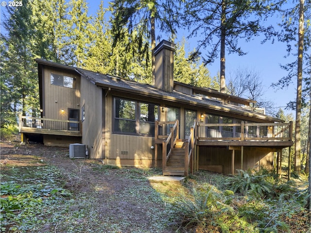 back of house featuring central AC and a deck