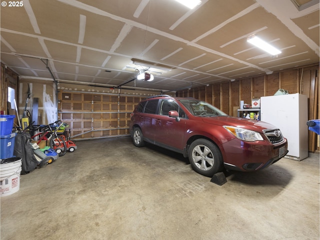 garage with a garage door opener and a carport