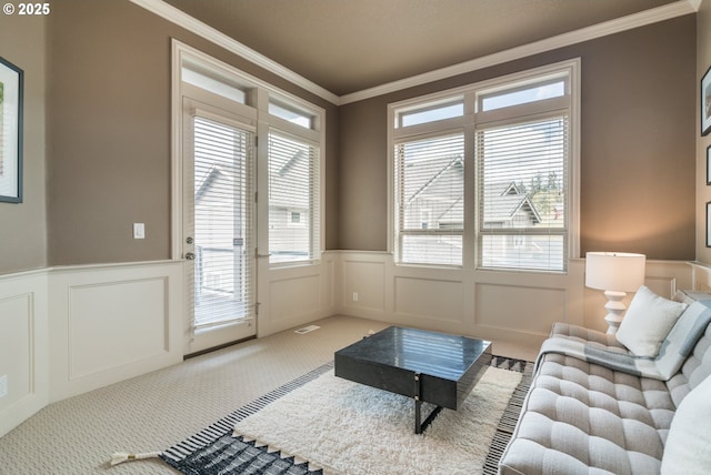 2640 NW Birkendene St, Portland, OR 97229 - living room featuring crown molding, a decorative wall, carpet, plenty of natural light, and wainscoting