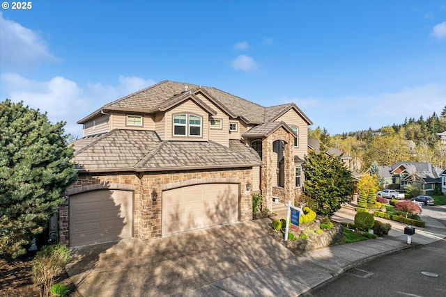 2640 NW Birkendene St, Portland, OR 97229 - view of front of property with an attached garage, concrete driveway, and stone siding