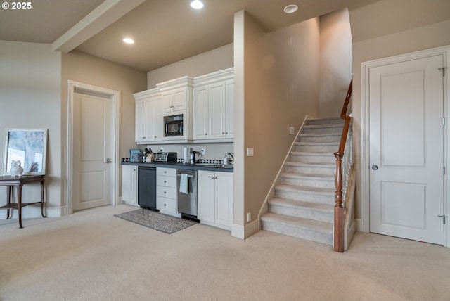 2640 NW Birkendene St, Portland, OR 97229 - kitchen featuring black microwave, light carpet, dark countertops, white cabinetry, and baseboards