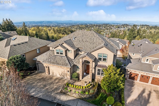 2640 NW Birkendene St, Portland, OR 97229 - traditional-style home with driveway, an attached garage, and stone siding