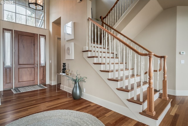 2640 NW Birkendene St, Portland, OR 97229 - entrance foyer with stairway, wood finished floors, a high ceiling, and baseboards