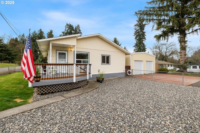 view of front of house featuring a garage, fence, a deck, and a front lawn