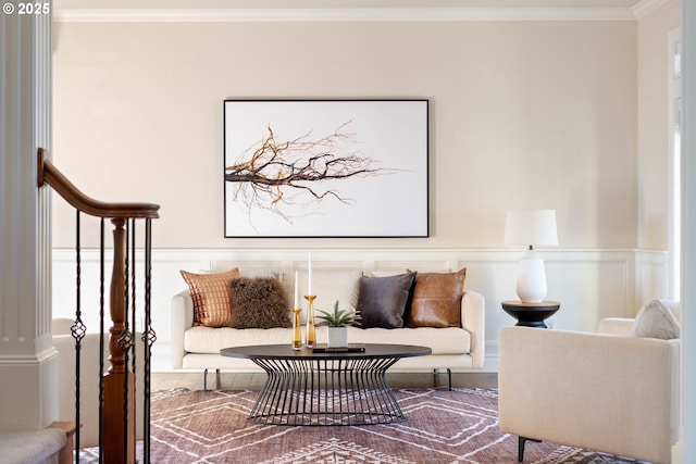 living area featuring a wainscoted wall and ornamental molding