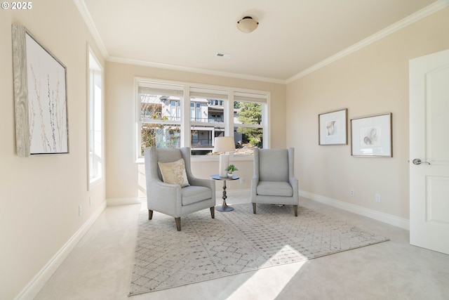 sitting room featuring baseboards, ornamental molding, and carpet flooring