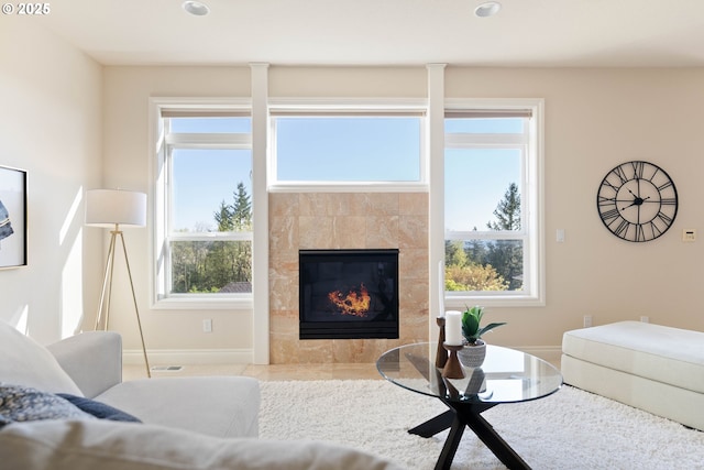 living room with a fireplace, baseboards, and recessed lighting