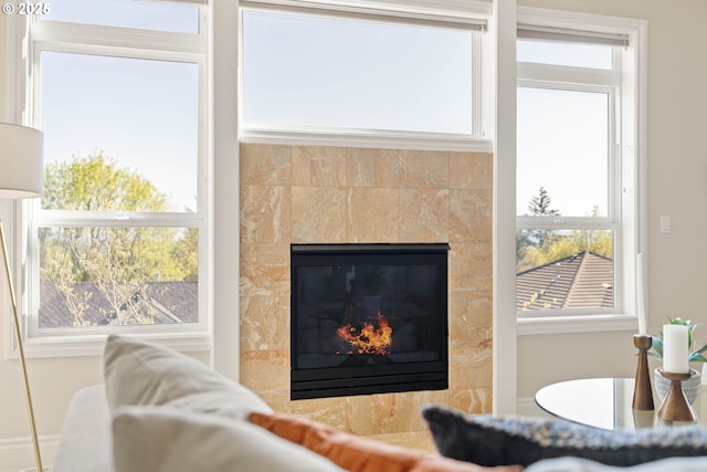 living room featuring a tile fireplace