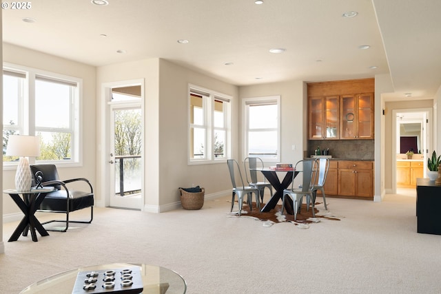 dining room featuring baseboards, light carpet, and recessed lighting