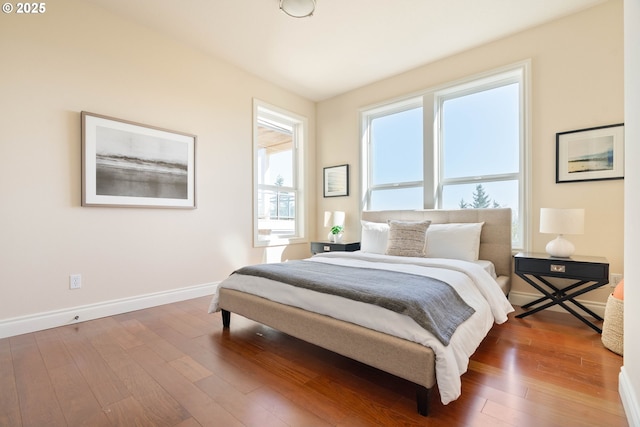 bedroom featuring baseboards and hardwood / wood-style flooring