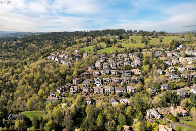 drone / aerial view with a residential view and a wooded view