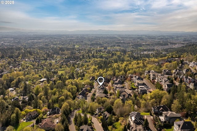 birds eye view of property featuring a residential view and a wooded view